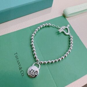 Tiffany & Co. Silver Bead Bracelet with Padlock Charm